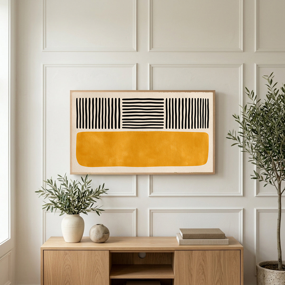 Abstract lines and color block art on a TV above a light oak sideboard with olive branches in a bright living room