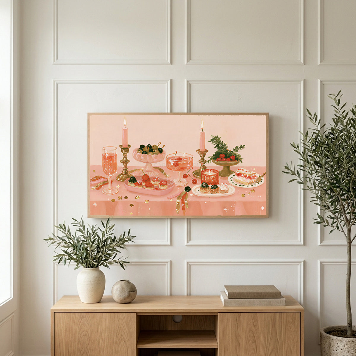 Party table still life art on a TV above a light oak sideboard with olive branches in a bright living room