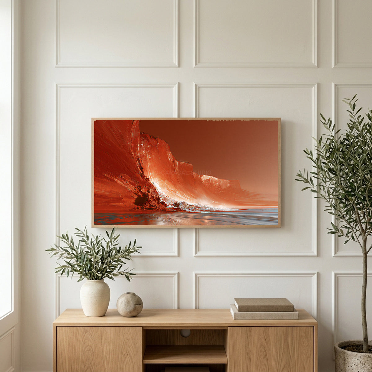 Red sea cliffs art on a TV above a light oak sideboard with olive branches in a bright living room