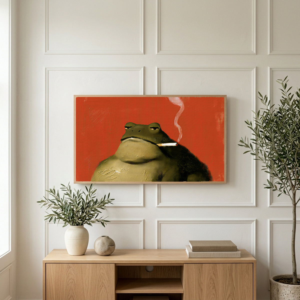 Smoking toad art on a TV above a light oak sideboard with olive branches in a bright living room