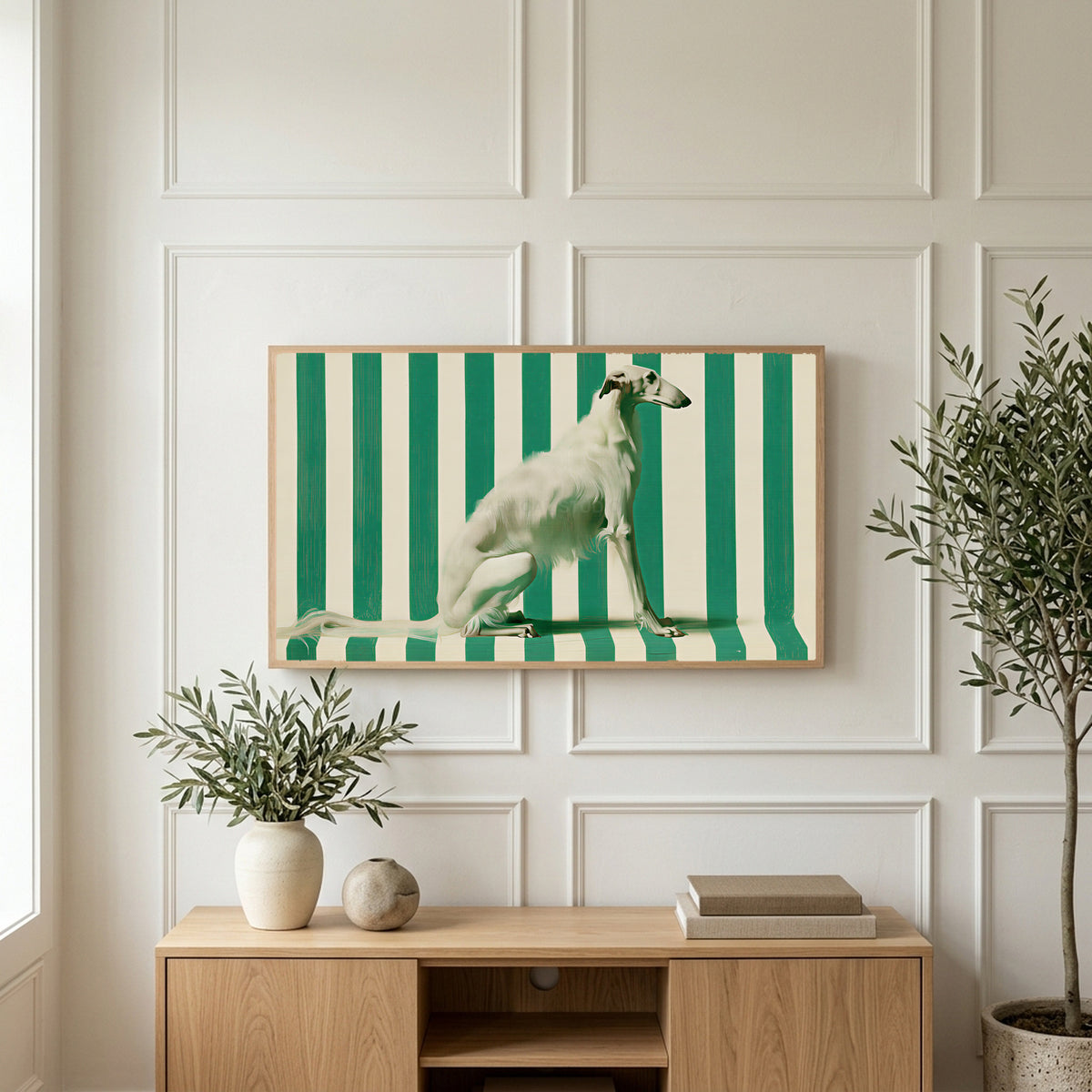 Borzoi art on a TV above a light oak sideboard with olive branches in a bright living room