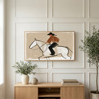 Cowboy on a horse art on a TV above a light oak sideboard with olive branches in a bright living room