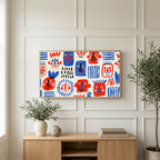 Doodle faces art on a TV above a light oak sideboard with olive branches in a bright living room