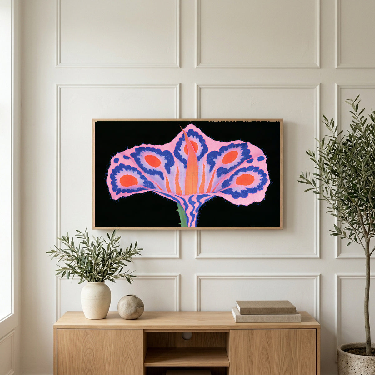 Surreal flower art on a TV above a light oak sideboard with olive branches in a bright living room