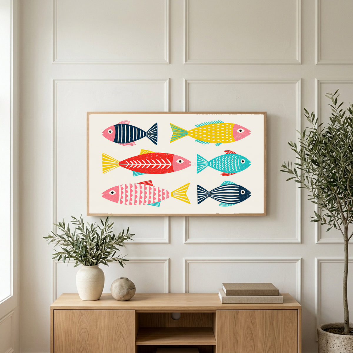 Linocut fish art on a TV above a light oak sideboard with olive branches in a bright living room