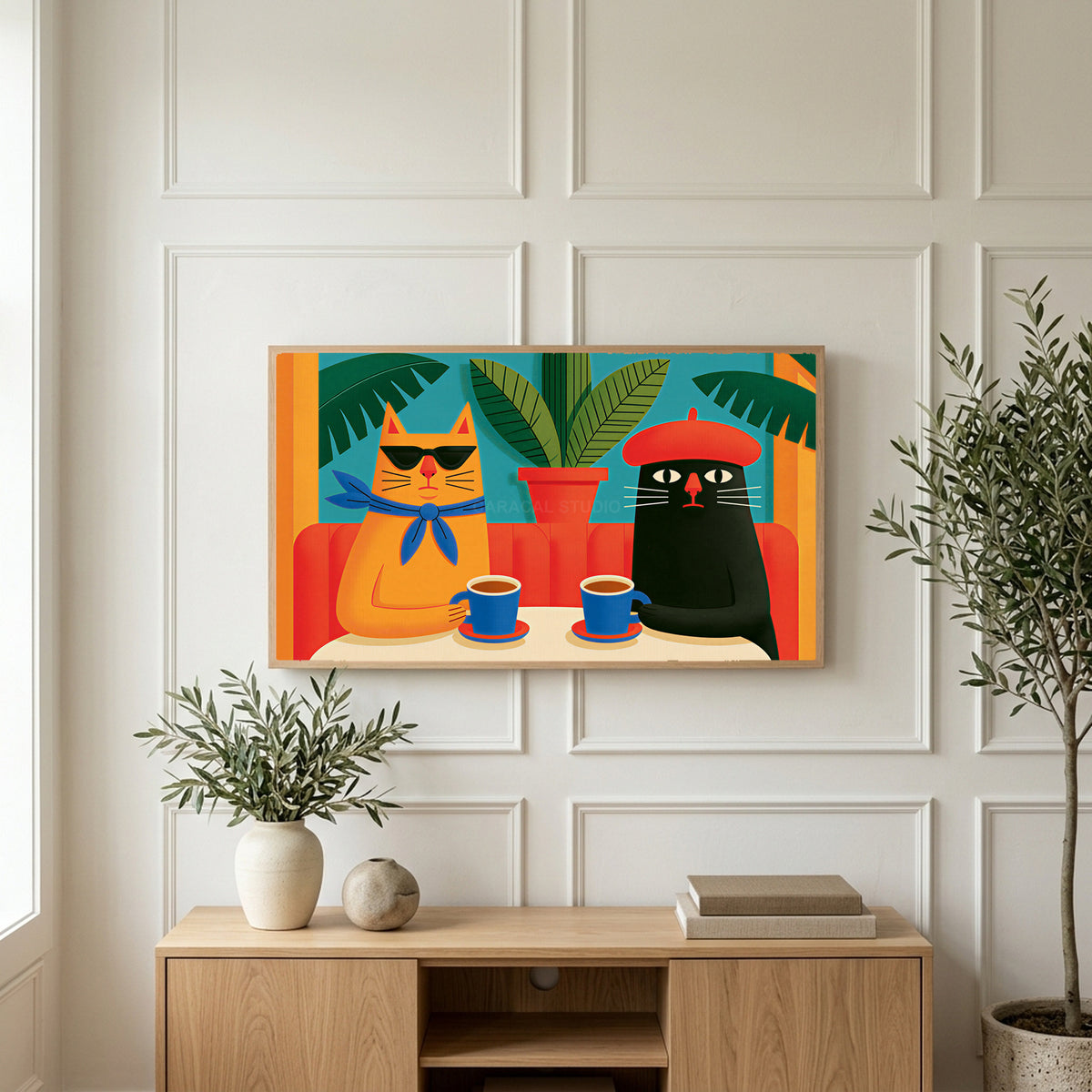 Funny cafe cats art on a TV above a light oak sideboard with olive branches in a bright living room