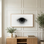 Black and white eye art on a TV above a light oak sideboard with olive branches in a bright living room