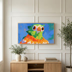 Parrot in a sweater art on a TV above a light oak sideboard with olive branches in a bright living room