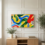Colorful brushstroke loops art on a TV above a light oak sideboard with olive branches in a bright living room