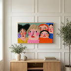 Funny faces portrait art on a TV above a light oak sideboard with olive branches in a bright living room