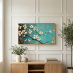 Dogwood blossom art on a TV above a light oak sideboard with olive branches in a bright living room