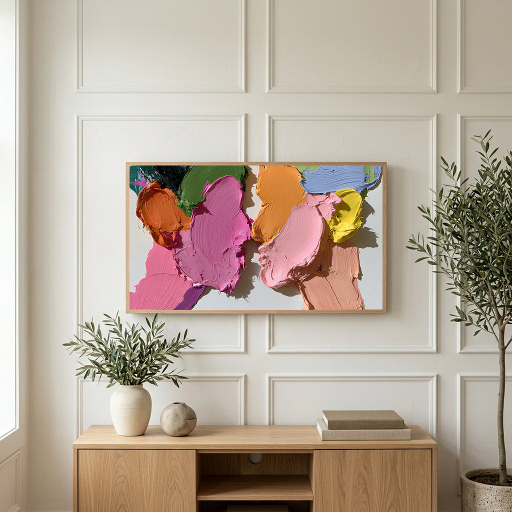 Pastel paint strokes art on a TV above a light oak sideboard with olive branches in a bright living room