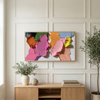Pastel paint strokes art on a TV above a light oak sideboard with olive branches in a bright living room