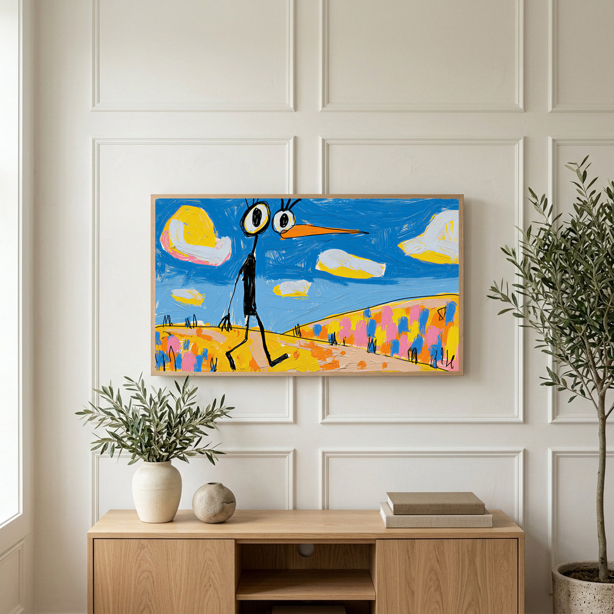 Funny alien bird art on a TV above a light oak sideboard with olive branches in a bright living room