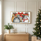 Cats under a gift box TV art above an oak sideboard next to a decorated Christmas tree
