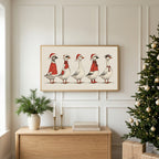 Geese in Santa hats TV art above an oak sideboard next to a decorated Christmas tree