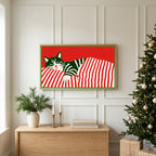 Sleeping cat and candy cane stripes TV art above an oak sideboard next to a decorated Christmas tree