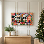 Folk art Christmas village TV art above an oak sideboard next to a decorated Christmas tree
