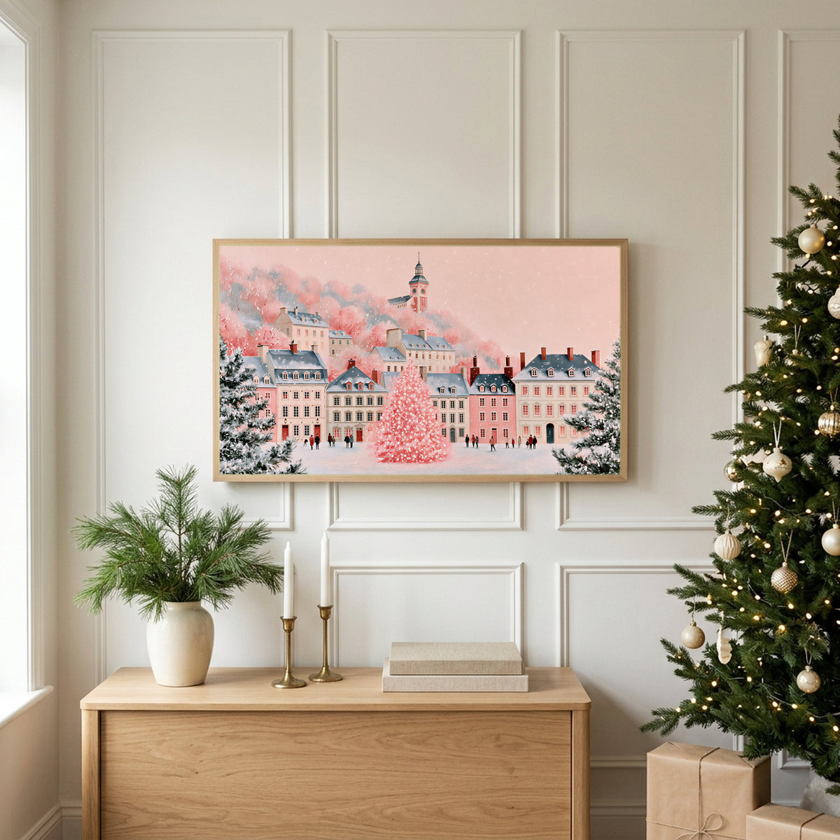 Pink Christmas village TV art above an oak sideboard next to a decorated Christmas tree