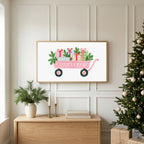 Pink wagon with gifts TV art above an oak sideboard next to a decorated Christmas tree