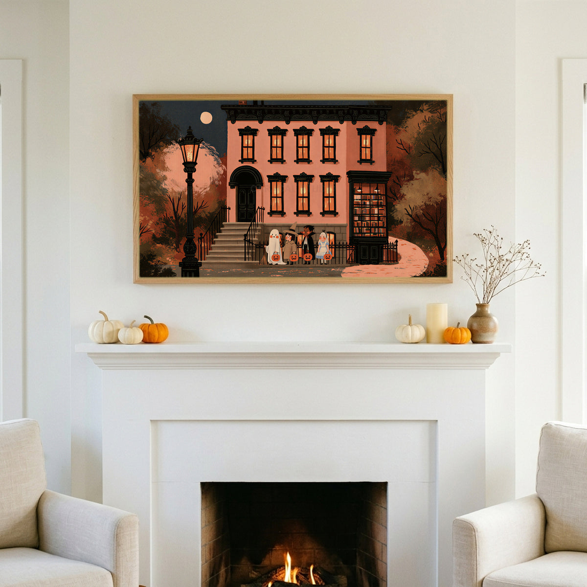 Trick or treat brownstone TV art above a white fireplace with small pumpkins on the mantel
