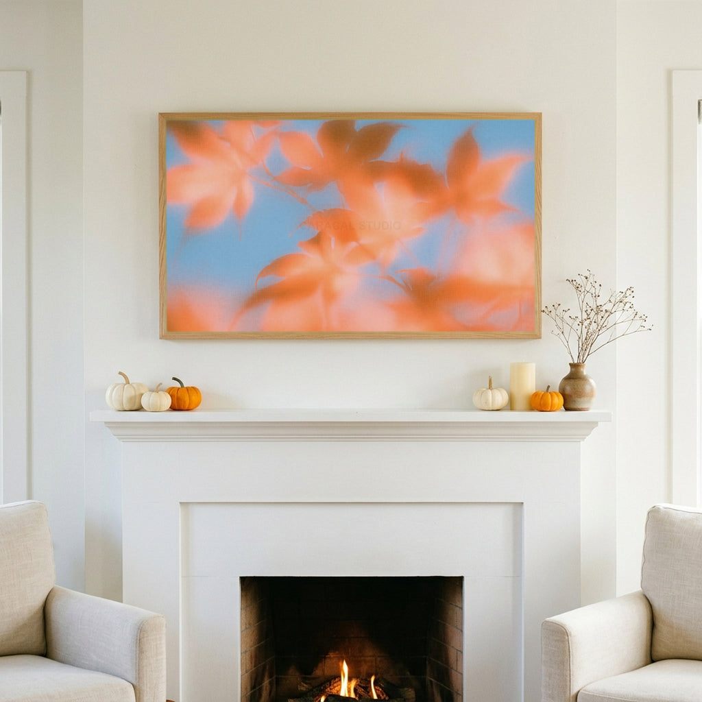 Autumn leaves TV art above a white fireplace with small pumpkins on the mantel