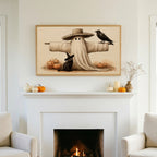 Halloween TV art above a white fireplace with small pumpkins on the mantel
