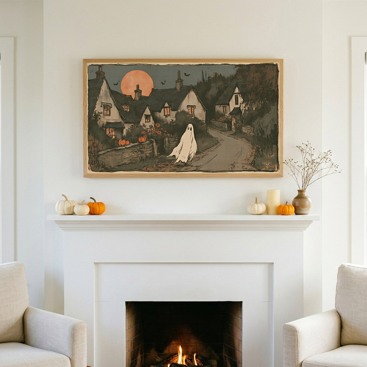 Halloween TV art above a white fireplace with small pumpkins on the mantel