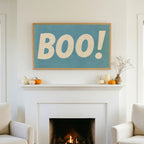 Halloween TV art above a white fireplace with small pumpkins on the mantel