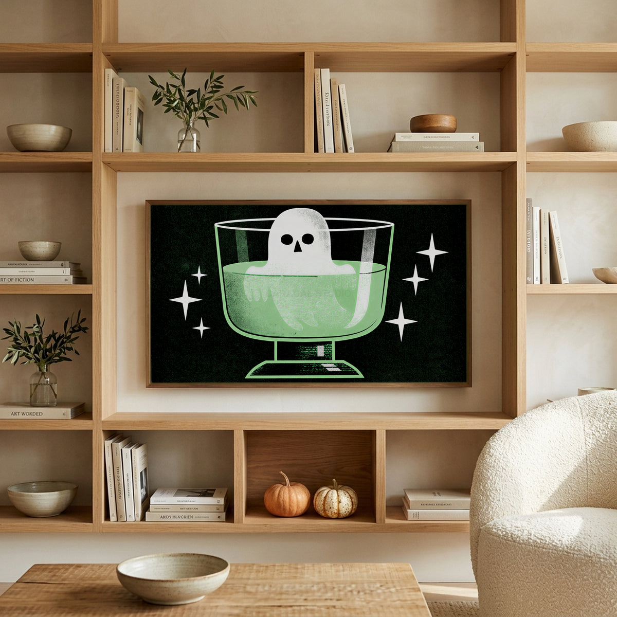 Ghost in a potion glass art on a TV in built-in oak shelves with pumpkins and books