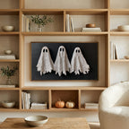 Textured ghosts art on a TV in built-in oak shelves with pumpkins and books