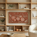 Folk art pumpkins art on a TV in built-in oak shelves with pumpkins and books