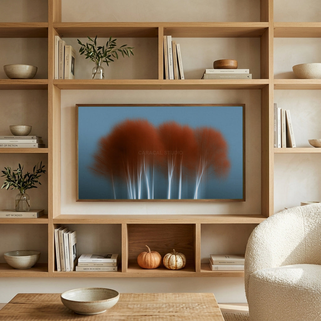 Abstract birch tree art on a TV in built-in oak shelves with pumpkins and books