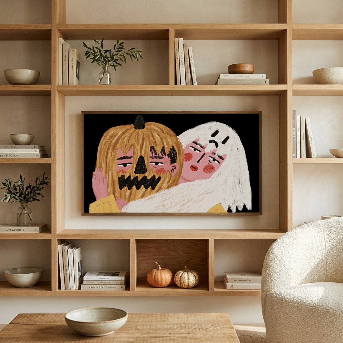 Jack-o'-lantern and ghost art on a TV in built-in oak shelves with pumpkins and books