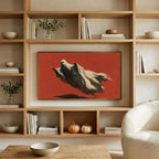Flying ghost art on a TV in built-in oak shelves with pumpkins and books