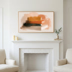 Book stack art above a white fireplace with candles and eucalyptus on the mantel