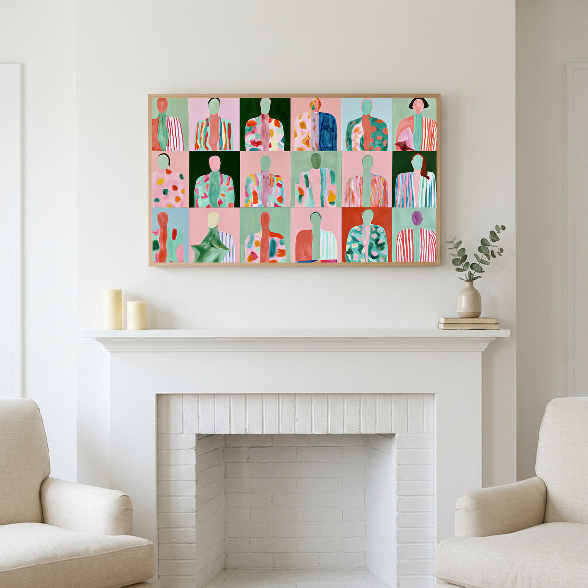 Faceless portraits art above a white fireplace with candles and eucalyptus on the mantel