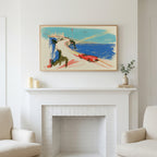 Red car on a coastal road art above a white fireplace with candles and eucalyptus on the mantel