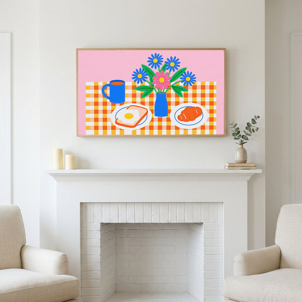 Frame TV art above a white fireplace with candles and eucalyptus on the mantel