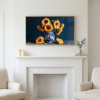 Sunflower still life art above a white fireplace with candles and eucalyptus on the mantel