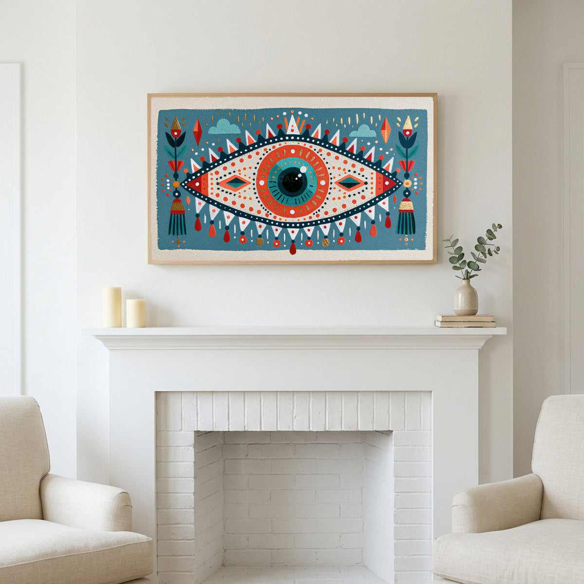Folk art mystic eye art above a white fireplace with candles and eucalyptus on the mantel