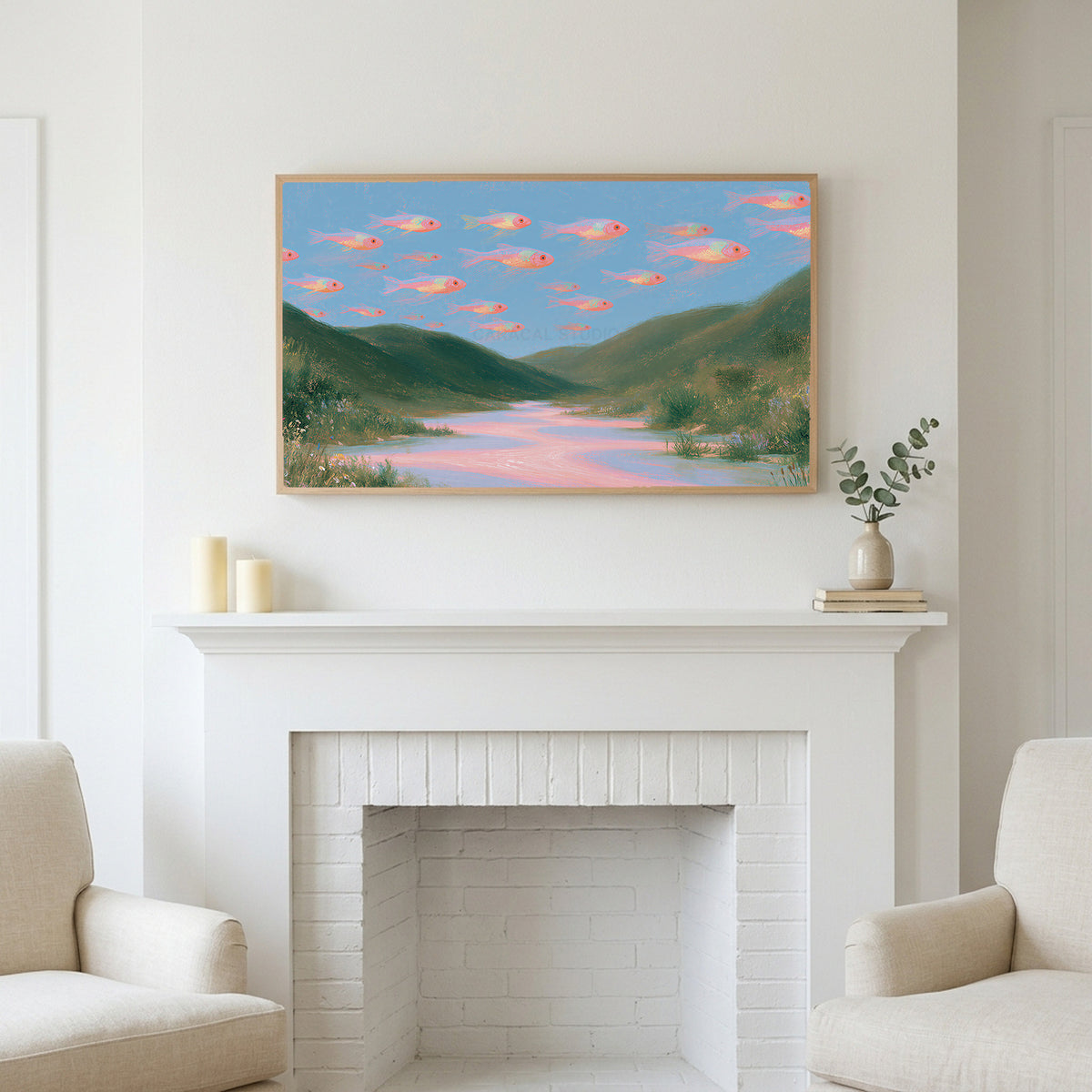 Flying fish art above a white fireplace with candles and eucalyptus on the mantel