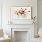Soft wildflowers art above a white fireplace with candles and eucalyptus on the mantel