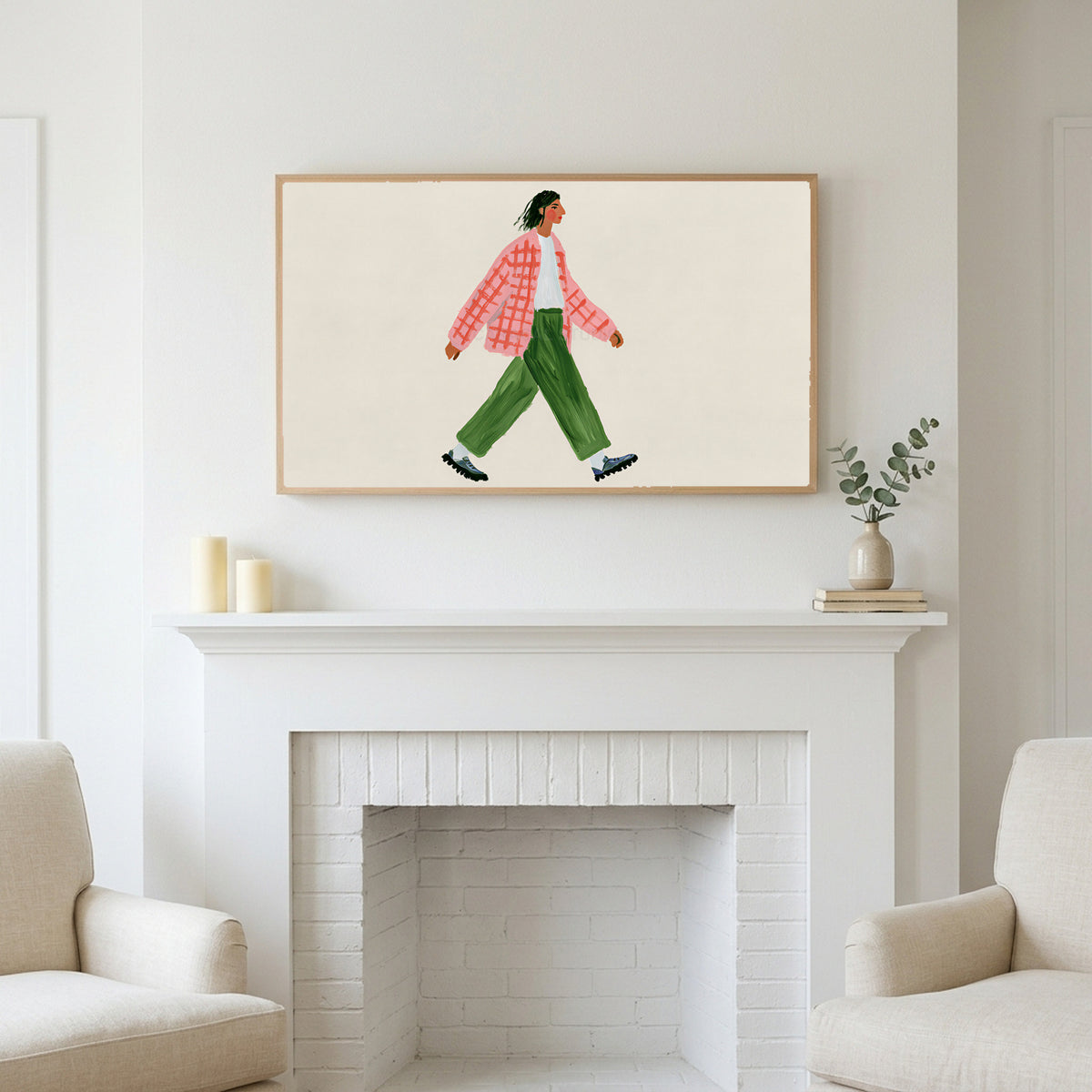 Frame TV art above a white fireplace with candles and eucalyptus on the mantel
