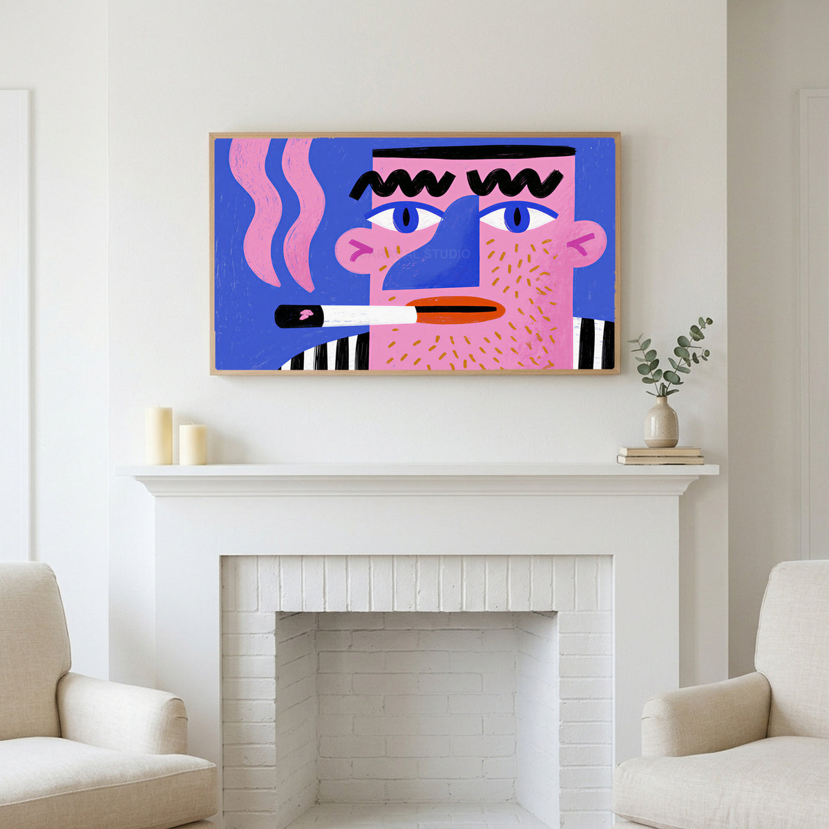 Frame TV art above a white fireplace with candles and eucalyptus on the mantel