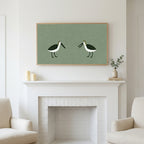 Frame TV art above a white fireplace with candles and eucalyptus on the mantel