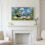 Picnic reader in a meadow art above a white fireplace with candles and eucalyptus on the mantel