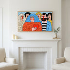 Colorful naive crowd with a heart art above a white fireplace with candles and eucalyptus on the mantel