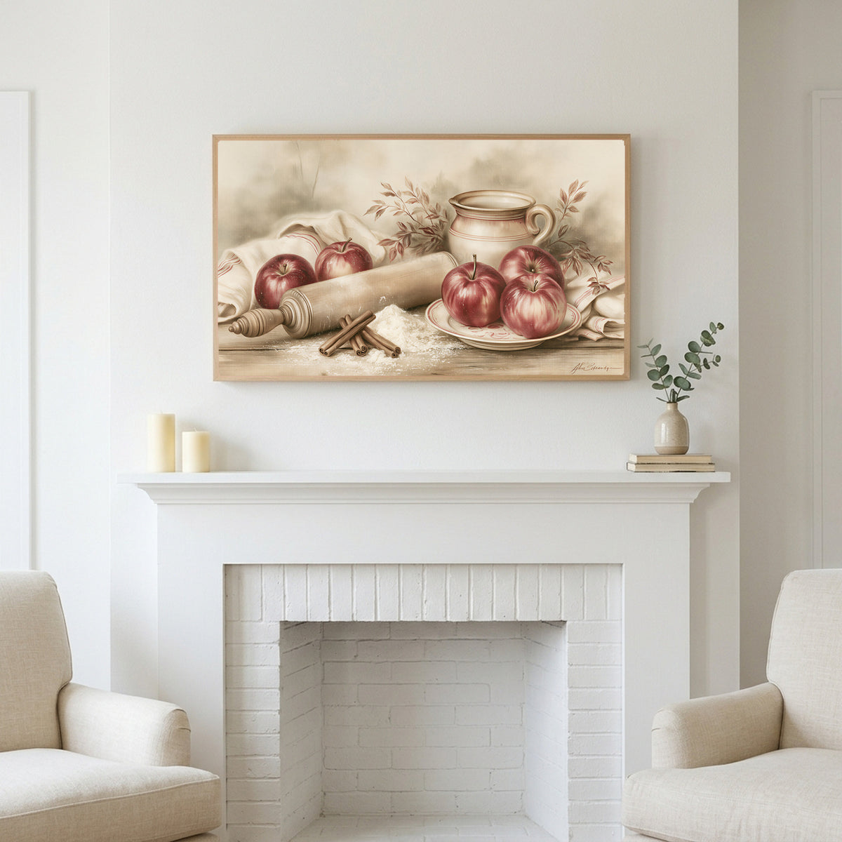 Farmhouse apples art above a white fireplace with candles and eucalyptus on the mantel