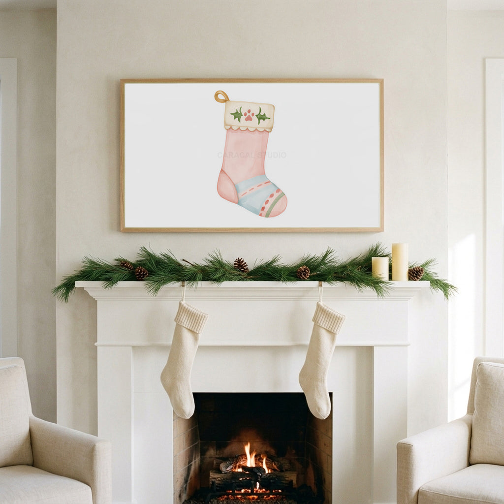 Cat stocking art on a TV above a white fireplace with a pine garland and cream stockings